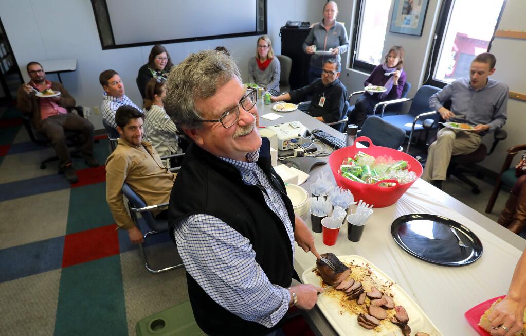 Chris Smith celebrated his 40th anniversary with the newsroom at the Press Democrat on Tuesday with tri-tip and smoked turkey from Angelo's Smokehouse and salads made by his wife and food writer Diane Peterson. (photo by John Burgess/The Press Democrat)