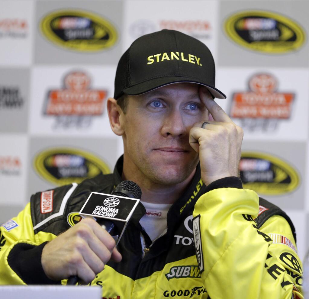 Carl Edwards answers questions from reporters during a media conference after qualifying for the pole position for Sunday's NASCAR Sprint Cup Series auto race Saturday, June 25, 2016, in Sonoma, Calif. (AP Photo/Ben Margot)