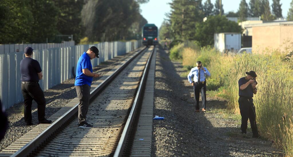 Rohnert Park Department of Public Safety officials document the scene of SMART train vs bicyclist fatality at Golf Course Drive in Rohnert Park, Friday, June 28, 2019. It is the second train fatality in as many days at the same location. (Kent Porter / The Press Democrat) 2019