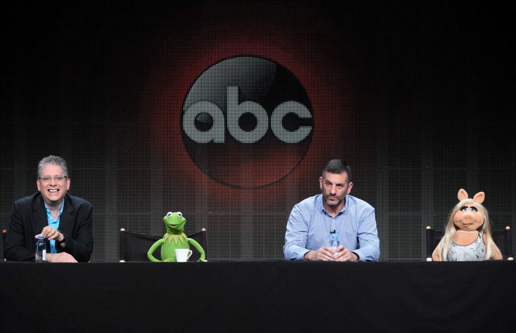 Writer/executive producer Bill Prady, from left, Kermit the Frog, writer/executive producer Bob Kushell and Miss Piggy participate in 'The Muppets' panel at the Disney/ABC Summer TCA Tour at the Beverly Hilton Hotel on Tuesday, Aug. 4, 2015, in Beverly Hills, Calif. (Photo by Richard Shotwell/Invision/AP)