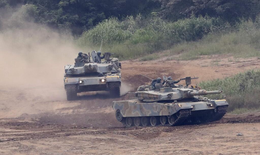 South Korean army's K-1 tanks move during a military exercise in Paju, South Korea, Tuesday, Sept. 5, 2017. South Korean warships conducted live-fire exercises at sea Tuesday as Seoul continued its displays of military capability following U.S. warnings of a 'massive military response' after North Korea detonated its largest-ever nuclear test explosion. (AP Photo/Lee Jin-man)