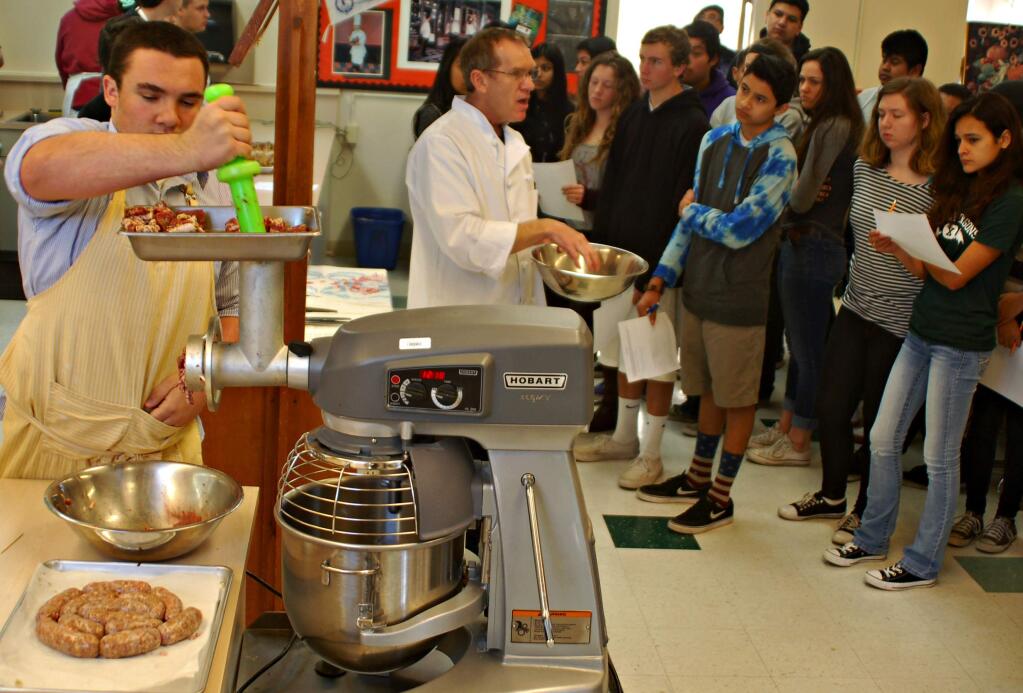 Lorna Sheridan/Index-TribuneSonoma Valley High School Culinary Arts teacher Jonathan Beard teaches freshmen how the sausage is made, as senior Vince Caruso operates the grinder.