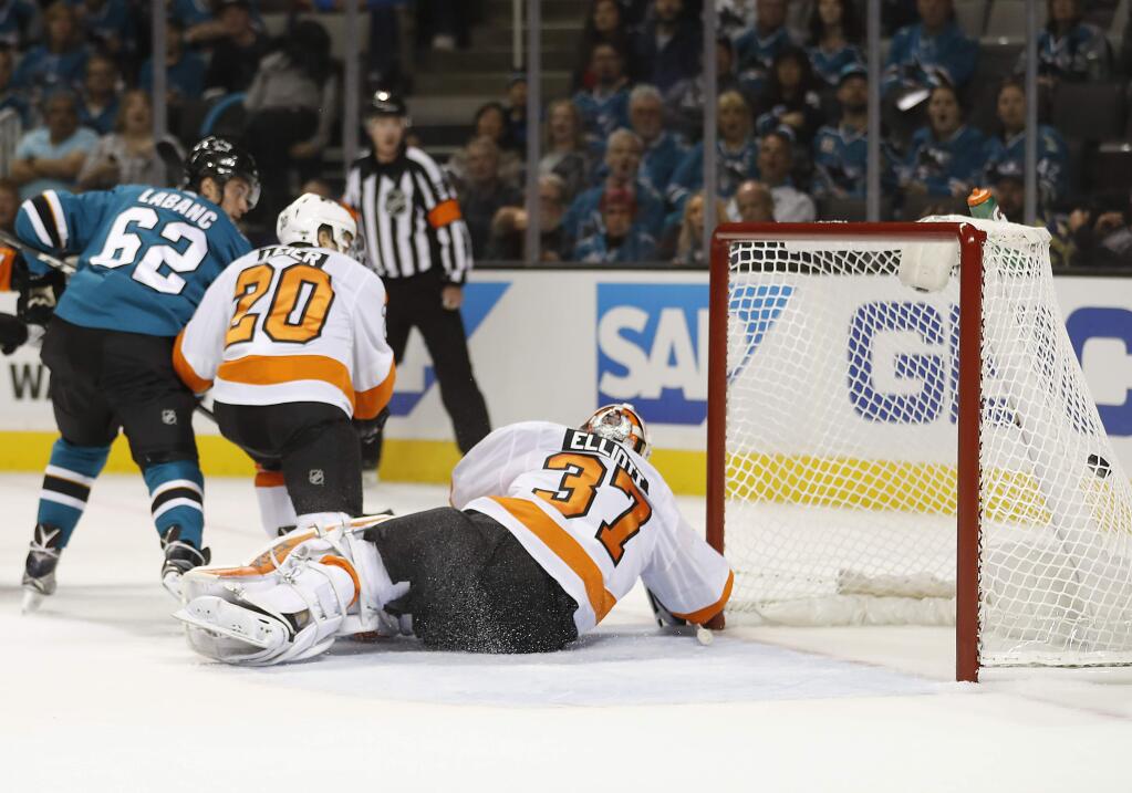 Philadelphia Flyers goalie Brian Elliott (37) can't stop a goal by San Jose Sharks right wing Kevin Labanc (62) during the first period Wednesday, Oct. 4, 2017, in San Jose. (AP Photo/Tony Avelar)