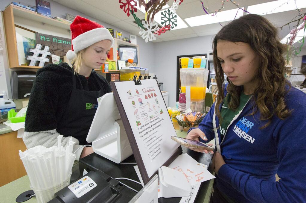 Left, Anabelle Hunter, 14, takes an order from fellow-student Caroline Student, 14. The No Name Cafe at Sonoma Valley High School is scheduled to close. The popular meeting place will sell their last snacks on Tuesday, Dec. 18. ( (Photo by Robbi Pengelly/Index-Tribune)