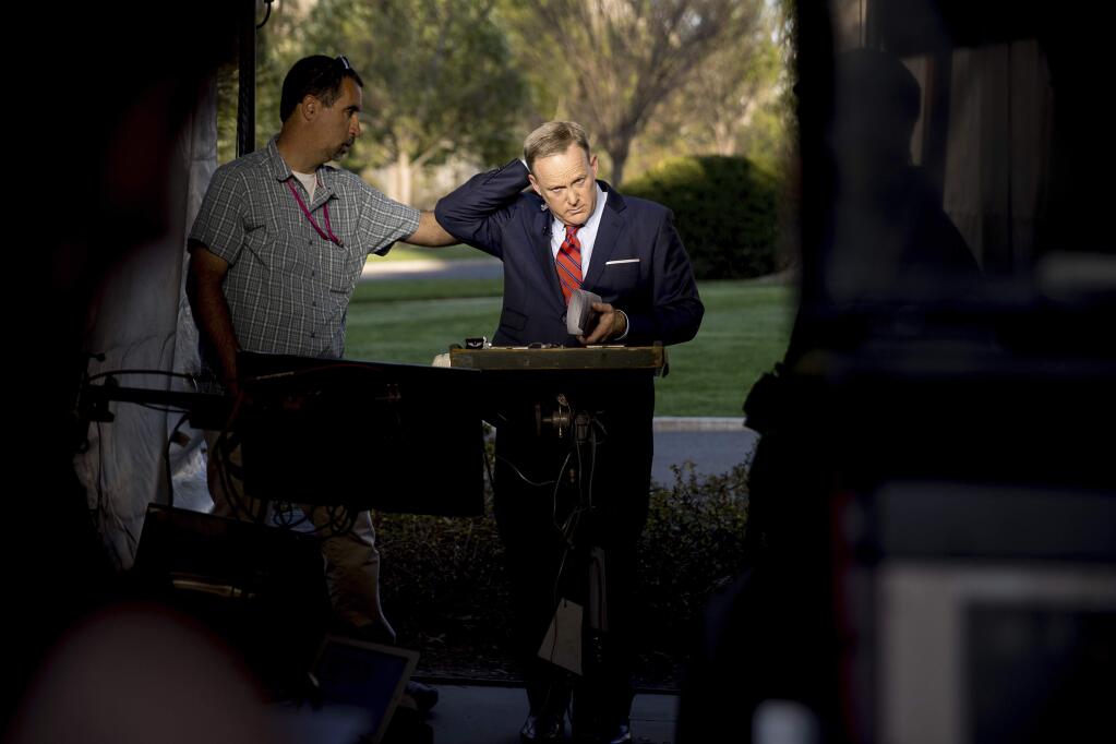 White House press secretary Sean Spicer finishes a cable news interview on the North Lawn of the White House, Tuesday, April 11, 2017, in Washington. Spicer is apologizing for making an 'insensitive' reference to the Holocaust in earlier comments about Syrian President Bashar Assad's use of chemical weapons. (AP Photo/Andrew Harnik)