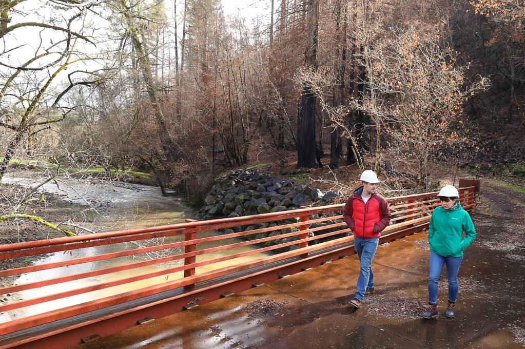 Sonoma County Agricultural Preservation and Open Space District associate planner Fraser Ross and community relations specialist Amy Ricard tour part of the district's land along Mark West Creek on Wednesday, March 14, 2018.(Christopher Chung/ The Press Democrat)