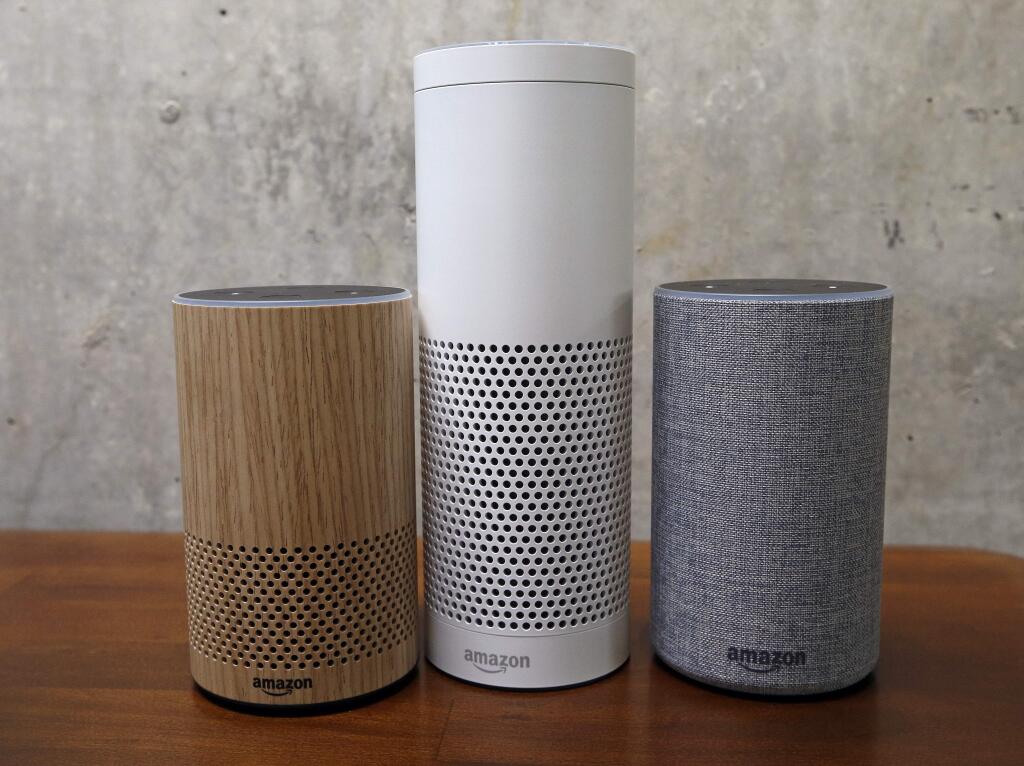 FILE - In this Sept. 27, 2017, file photo, Amazon Echo Plus, center, and other Echo devices sit on display during an event announcing several new Amazon products by the company in Seattle. Amazon says an 'unlikely' string of events prompted its Echo personal assistant device to record a Portland, Ore., family's private conversation and then send the recording to an acquaintance in Seattle. (AP Photo/Elaine Thompson, File)