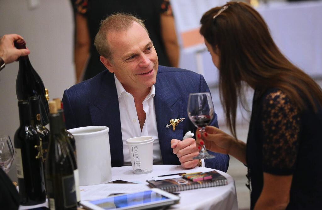 Jean-Charles Boisset, left, talks with Celine Calbrix, from France, about his wines during the Vinexpo Explorer event in Santa Rosa on Tuesday, September 25, 2018. (Christopher Chung/ The Press Democrat)