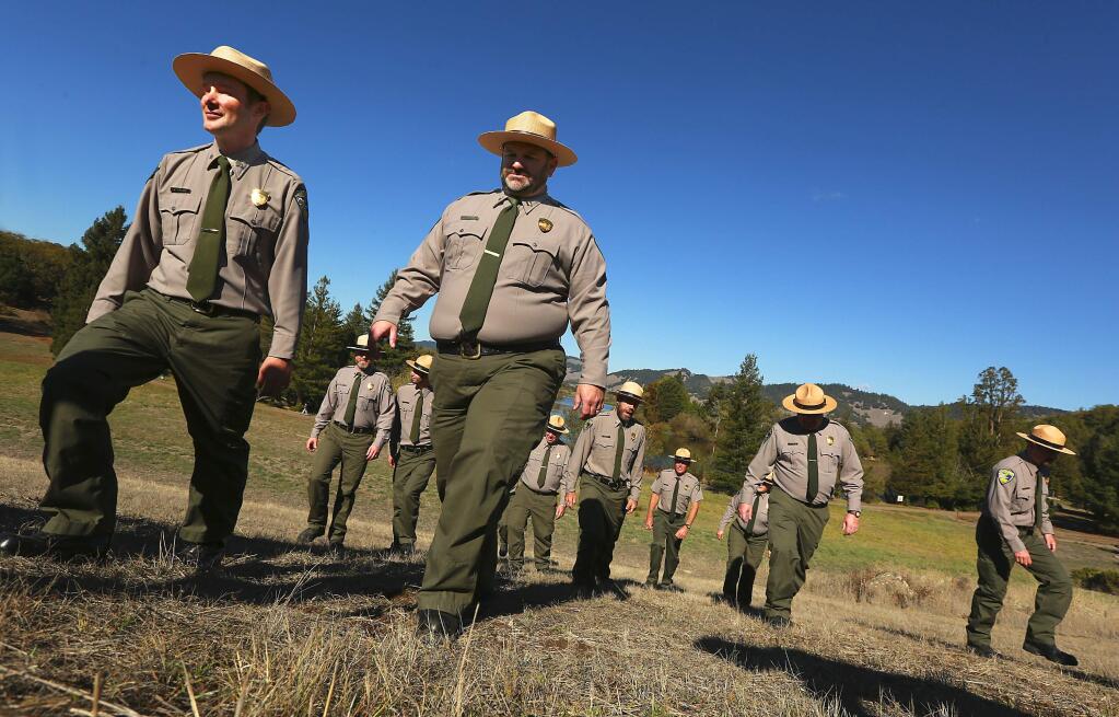 Sonoma County Park Rangers pose for pictures during a ceremony debuting their new uniforms and badges at Spring Lake in Santa Rosa on Tuesday. (JOHN BURGESS / The Press Democrat)