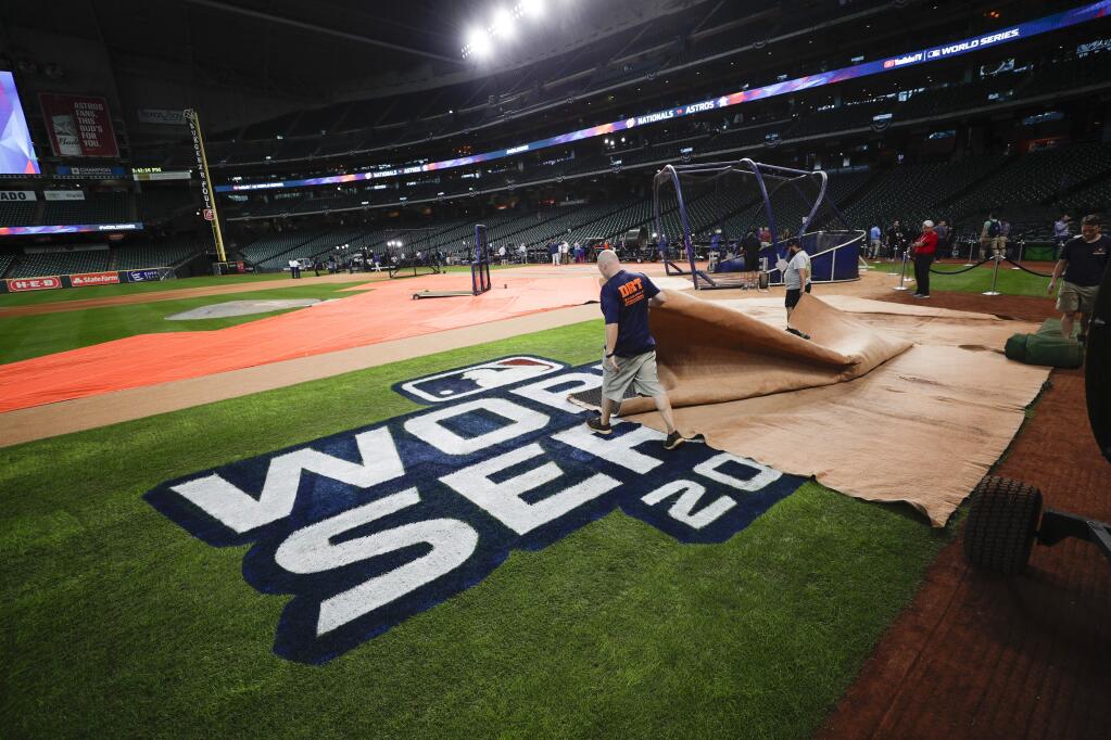 Members of the ground crew prepare the field during a practice day for baseball's World Series Monday, Oct. 21, 2019, in Houston. The Houston Astros face the Washington Nationals in Game 1 on Tuesday. (AP Photo/Eric Gay)