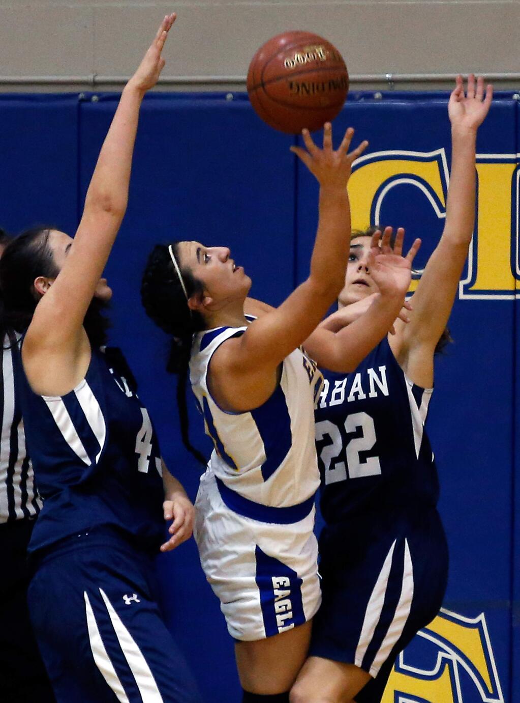 Cloverdale's Angel Bernardi (21), center, shoots between Urban's Iona Tangri (43), left, and Claire Beckstoffer (2) and draws a foul during first half of the NCS Division 5 semifinal girls basketball game between Urban and Cloverdale high schools in Cloverdale, California, on Wednesday, March 2, 2016. (Alvin Jornada / The Press Democrat)
