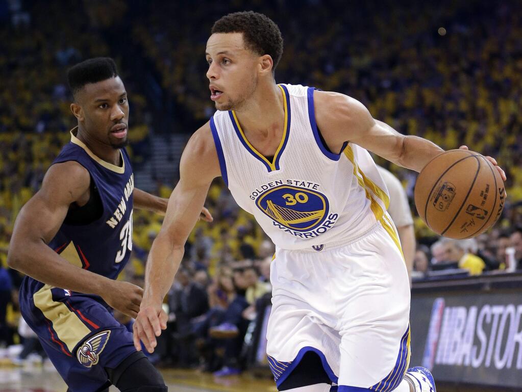 Golden State Warriors' Stephen Curry (30) dribbles past New Orleans Pelicans' Norris Cole during the first half in Game 2 of a first-round NBA basketball playoff series Monday, April 20, 2015, in Oakland, Calif. (AP Photo/Marcio Jose Sanchez)