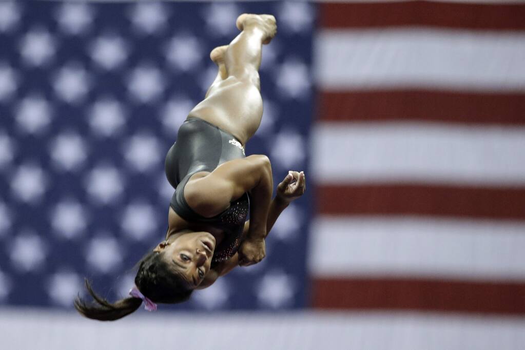 File-This Aug. 11, 2019, file photo shows Simone Biles practicing on vault for the senior women's competition at the 2019 U.S. Gymnastics Championships in Kansas City, Mo. Biles is the 2019 AP Female Athlete of the Year. She is the first gymnast to win the award twice and the first to win it in a non-Olympic year. (AP Photo/Charlie Riedel, File)