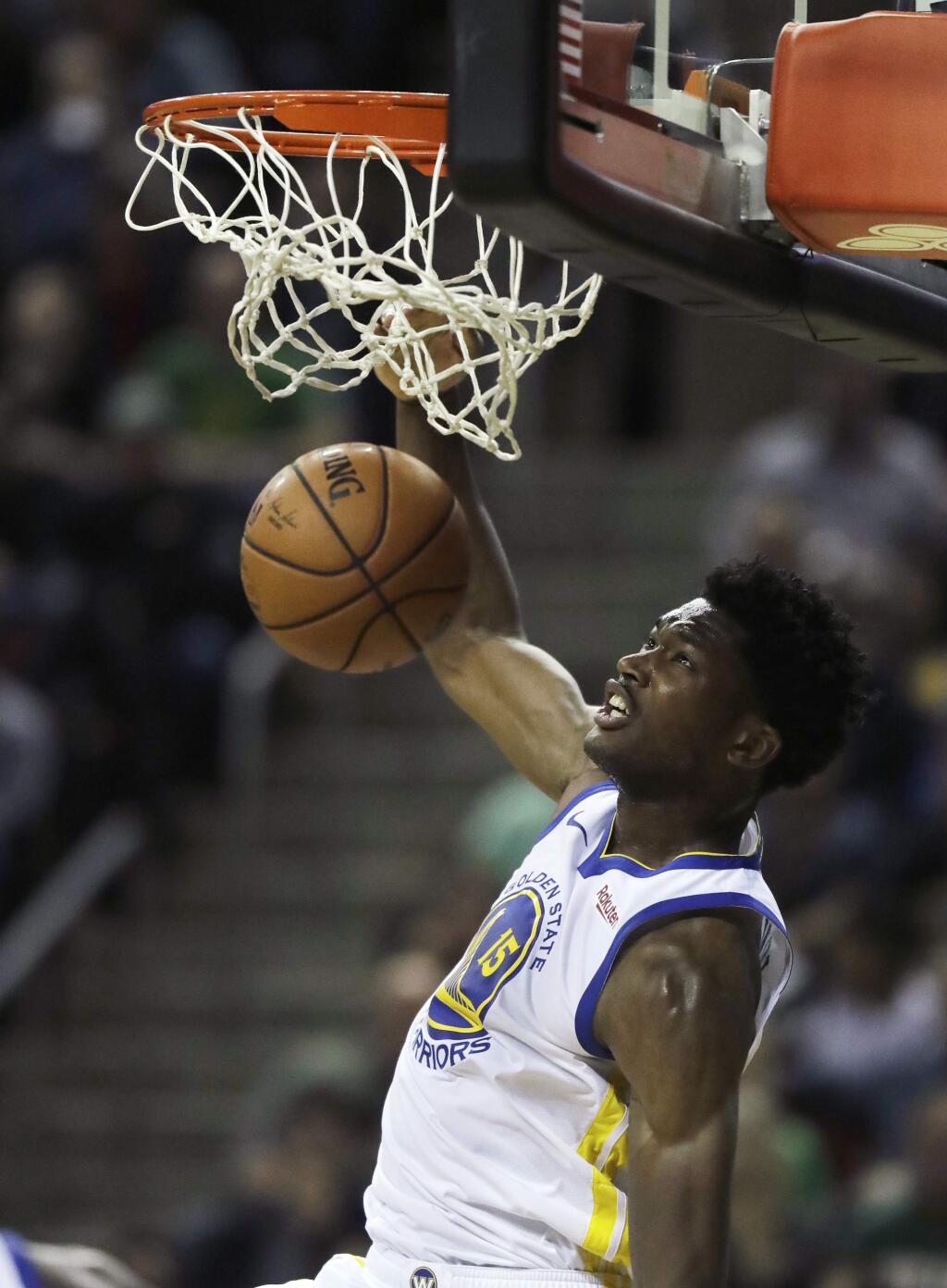 Golden State Warriors center Damian Jones dunks against the Sacramento Kings during the second half of a preseason game, Friday, Oct. 5, 2018, in Seattle. The Warriors won 122-94. (AP Photo/Ted S. Warren)