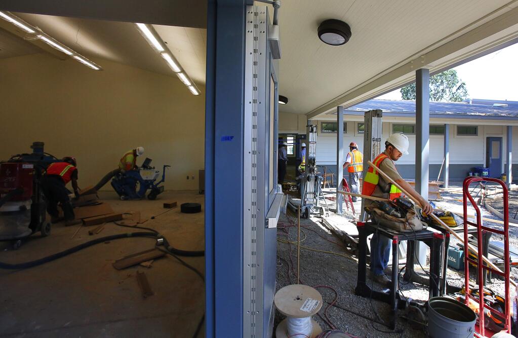 Michael Guthrie works on a new section of buildings for the Santa Rosa Charter School for the Arts campus. (CHRISTOPHER CHUNG / The Press Democrat)