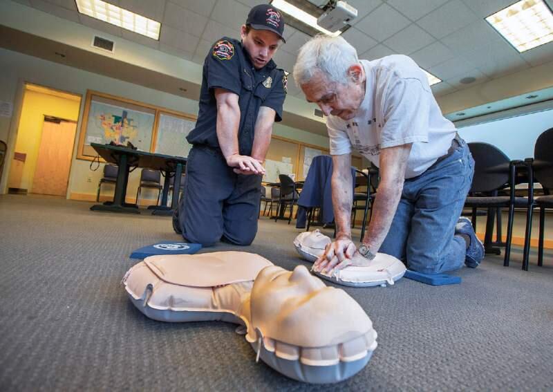 Robbi Pengelly/Index-Tribune file photo 2015Sonoma Valley paramedic engineer Ryan McCracken shows Bob Alwitt the most efficient way to administer CPR, a lifesaving technique useful in many emergencies. Sonoma Valley Fire and Rescue will be offering “hands-only” CPR training on Saturday, May 27.