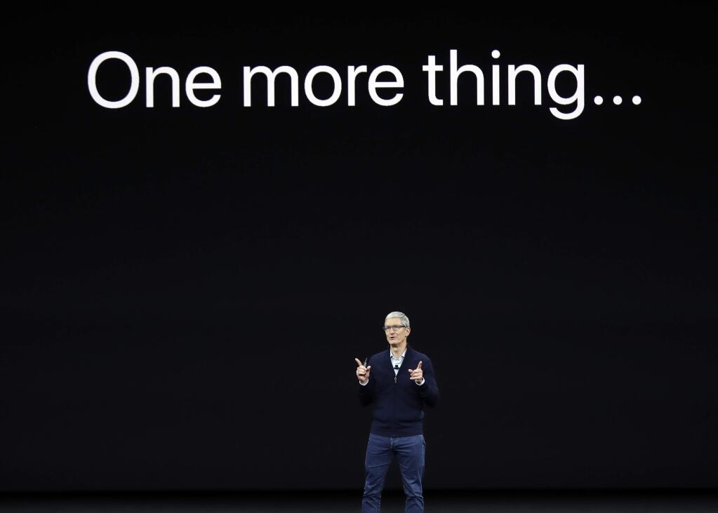 Apple CEO Tim Cook, announces the new iPhone X at the Steve Jobs Theater on the new Apple campus on Tuesday, Sept. 12, 2017, in Cupertino, Calif. (AP Photo/Marcio Jose Sanchez)