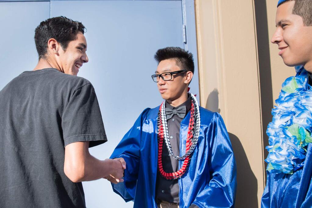 Manuel Rojas, Class of 2015 Cloverdale High School Graduate preparing for the ceremony. (Deborah Parrish / for The Press Democrat)
