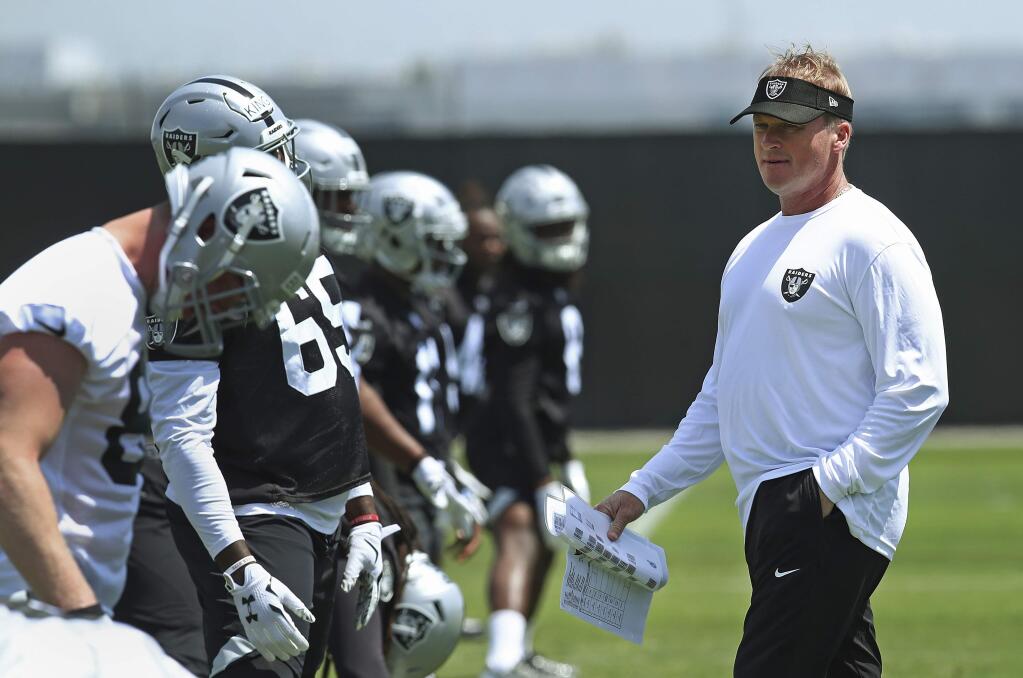 Oakland Raiders coach Jon Gruden, right, oversees practice on Friday, May 4, 2018, at the team's training facility in Alameda. (AP Photo/Ben Margot)