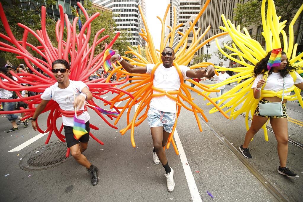 Christian Vidaure, left, Darrell Hardaway, and Jasmine Haygood, right, perform during the 45th annual San Francisco Gay Pride parade Sunday, June 28, 2015, in San Francisco. A large turnout was expected for gay pride parades across the U.S. following the landmark Supreme Court ruling that said gay couples can marry anywhere in the country. (AP Photo/ Tony Avelar)