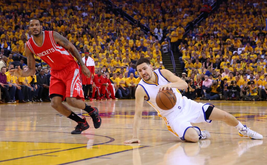 Golden State Warriors guard Klay Thompson slides while dribbling against Houston Rockets forward Trevor Ariza during Game 2 of the NBA Playoffs Western Conference Finals at Oracle Arena, in Oakland on Thursday, May 21, 2015. (Christopher Chung/ The Press Democrat)