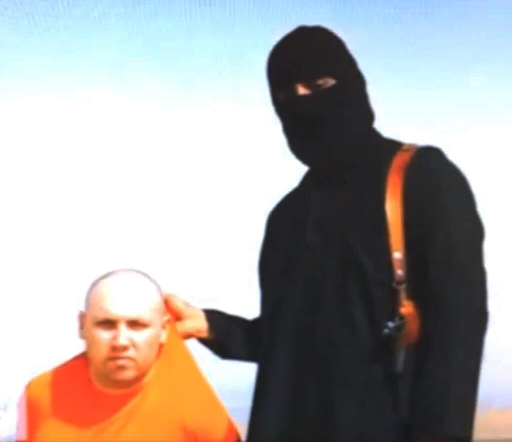 In this file still image from an undated video released by Islamic State militants on Tuesday, Aug. 19, 2014, purports to show journalist Steven Sotloff being held by the militant group. (AP Photo, File)