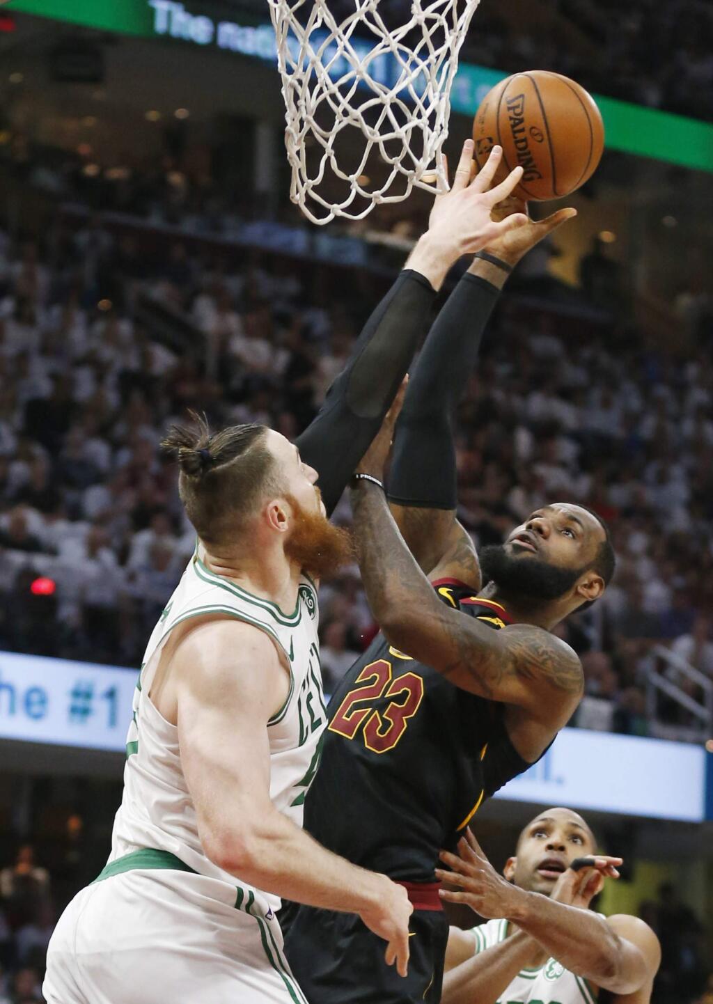 Cleveland Cavaliers' LeBron James, right, drives to the basket against Boston Celtics' Aron Baynes (46) during the first half of Game 6 of the NBA basketball Eastern Conference finals Friday, May 25, 2018, in Cleveland. (AP Photo/Ron Schwane)