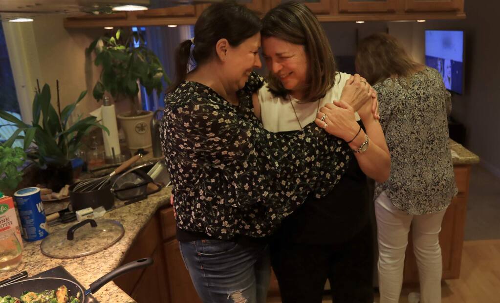 Kent Porter / The Press DemocratJayme Farmer, left, welcomes Martha Marquez to her family's Thanksgiving dinner on Thursday. Marquez and her husband, whose Fountaingrove home was destroyed by the Tubbs fire, were offered shelter by the Farmer family in Santa Rosa. The Oct. 9 firestorm also completely destroyed Paradise Ridge Winery, where Marquez and her husband worked.