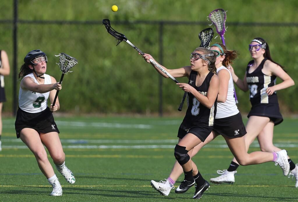 Windsor's Hailey Toste, right, and Sonoma Academy's Kate Roney go after a loose ball, during their lacrosse game in Santa Rosa on Tuesday, April 17, 2018. (Christopher Chung/ The Press Democrat)