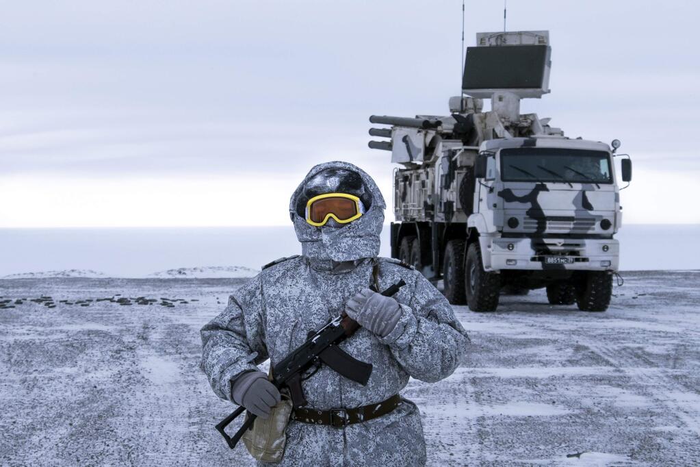 A Russian solder stands guard as Pansyr-S1 air defense system on the Kotelny Island, part of the New Siberian Islands archipelago located between the Laptev Sea and the East Siberian Sea, Russia. (VLADIMIR ISACHENKOV / Associated Press)