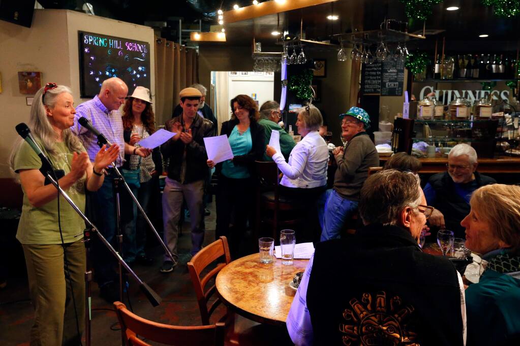 Guests sing traditional Irish folk songs together at Aqus Cafe which has become a hub for nearly daily community gatherings of all kinds, in Petaluma, California. Miriam Crowley, standing at left, sister of Aqus Cafe co-owner John Crowley, visits the cafe every other year to sing traditional Irish folk songs. (Alvin Jornada / The Press Democrat)