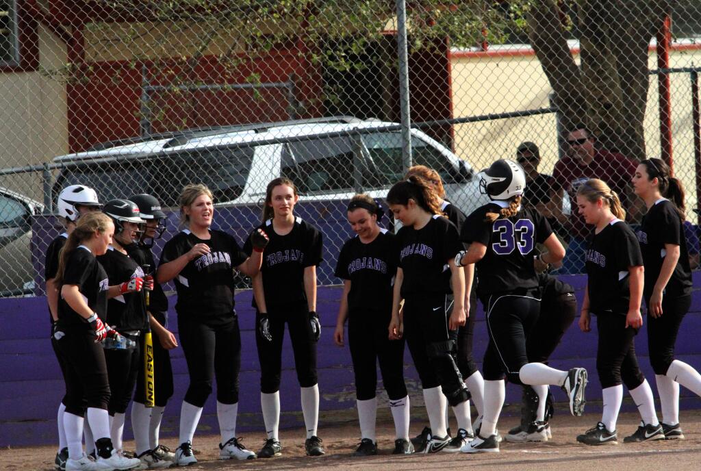 DWIGHT SUGIOKA/FOR THE ARGUS-COURIERPetaluma's T-Girls welcome home Joelle Krist (33) after her grand slam home run in a 19-11 win over Ukiah.
