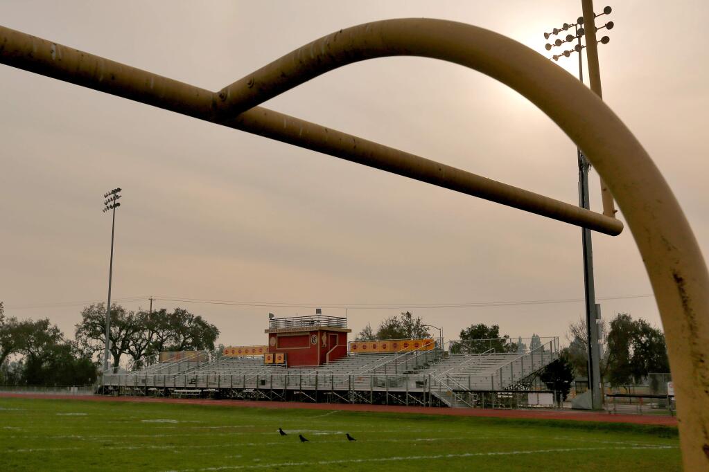 Smoke from the Camp fire in Butte County obscures the sun and sky above the Edward R. Monahan Memorial Stadium grandstand and Ed Lloyd Field at Cardinal Newman High School in Santa Rosa pictured on Tuesday, Nov. 13, 2018. (ALVIN JORNADA/PD)