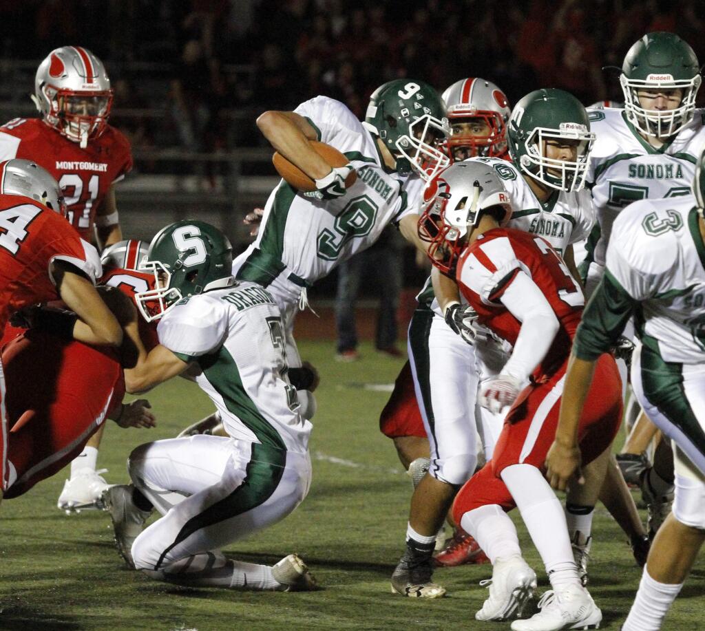 Bill Hoban/Index-TribuneSonoma's Josef Marenec (#9) tries to get a couple of extra yards during Friday night's game against Montgomery. The Dragons lost 41-13, but Manerec scored both Sonoma touchdowns - one on a 78-yard pass and the other on a 38-yard pass.