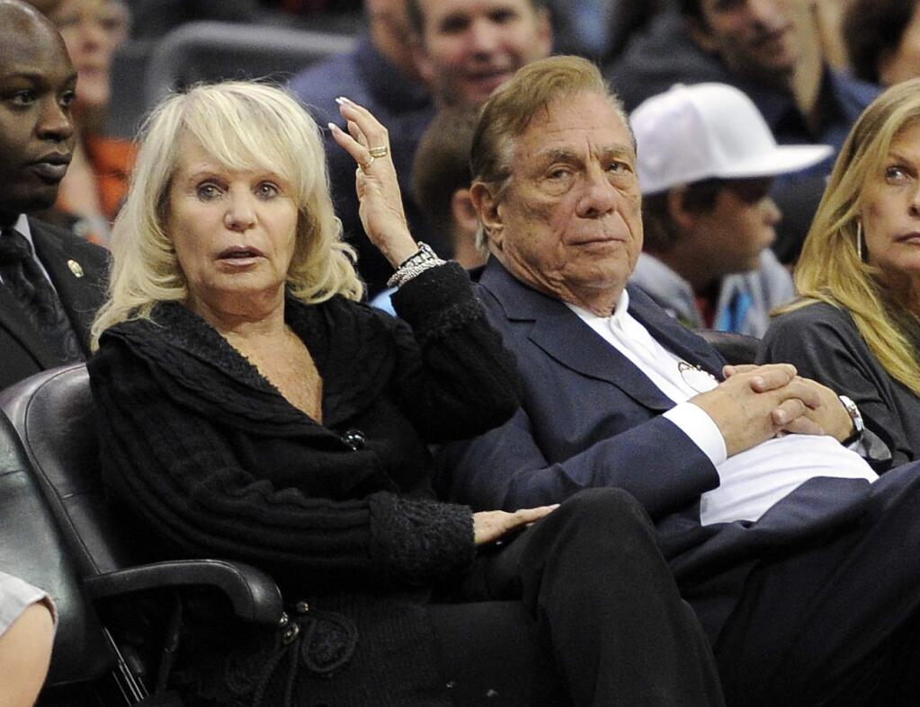 In this Nov. 12, 2010, file photo, Shelly Sterling sits with her husband, Donald Sterling, during the Los Angeles Clippers' NBA basketball game against the Detroit Pistons in Los Angeles. (AP Photo/Mark J. Terrill, File)
