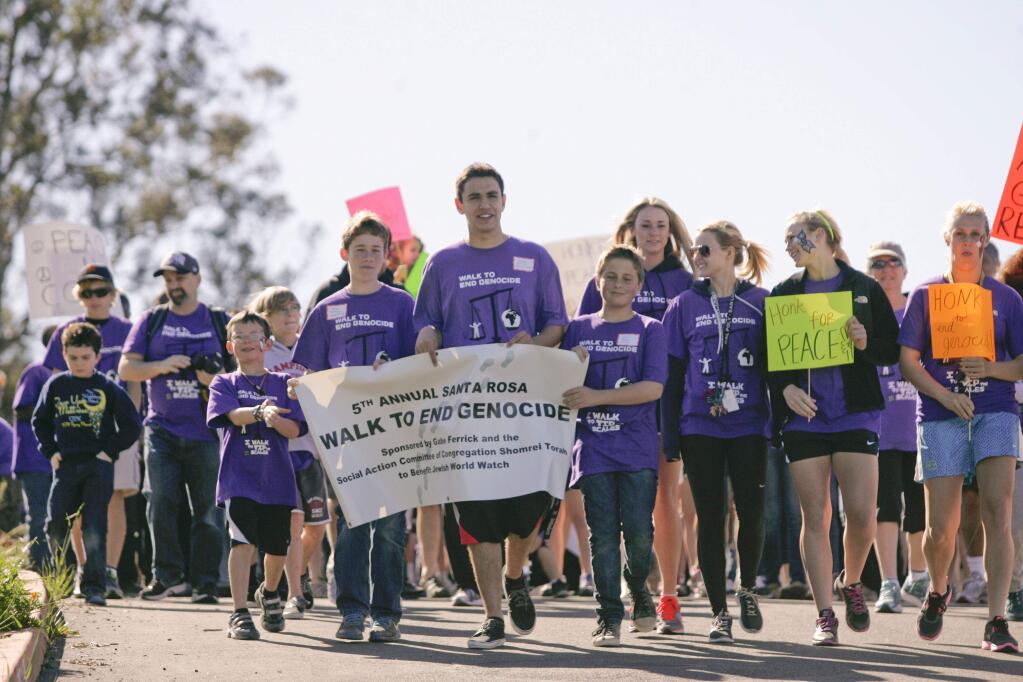 Gabrial 'Gabe' Ferrick, holding the middle of banner, leads the annual 'Walk to End Genocide' in Santa Rosa in 2013. (PD FILE)