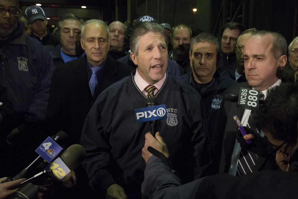 Patrick Lynch, head of the Patrolmen's Benevolent Association, speaks during a news conference after the bodies of two fallen NYPD police officers were transported from Woodhull Medical Center, Saturday, Dec. 20, 2014, in New York. An armed man walked up to two New York Police Department officers sitting inside a patrol car and opened fire Saturday afternoon, killing both officers before running into a nearby subway station and committing suicide, police said. (AP Photo/John Minchillo)