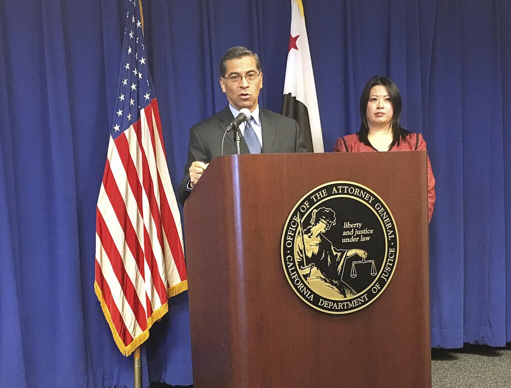 California Attorney General Xavier Becerra, left, and Tam Ma of the advocacy group, Health Access California, discuss a lawsuit filed by 19 attorneys general over President Donald Trump's decision to end health care subsidies during a news conference on Wednesday, Oct. 18, 2017 in Sacramento, Calif. Becerra is leading the lawsuit, which seeks an emergency order requiring that the payments continue to be made. (AP Photo/Jonathan J. Cooper)