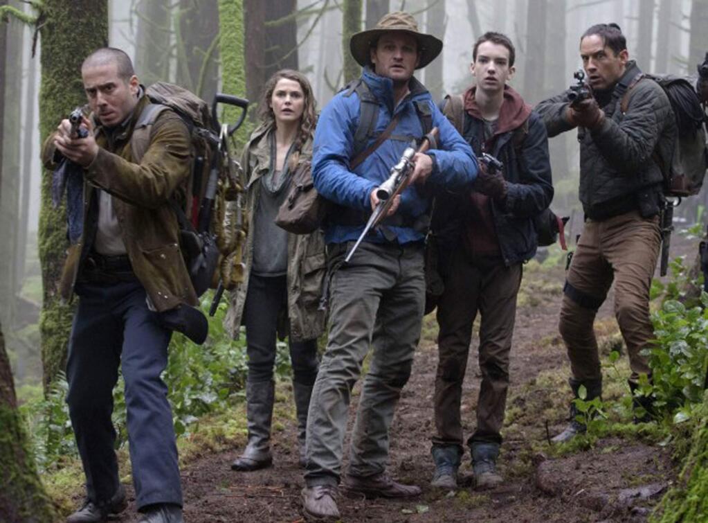 A band of survivors of a plague that has wiped out most of humanity, including main ape contact, Malcolm (Jason Clarke, center); and caregiver, Ellie (Keri Russell), confront a burgeoning ape population near San Francisco. 20th Century Fox
