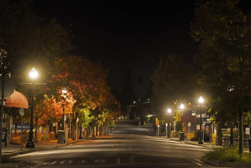 Empty streets in downtown Healdsburg Saturday evening just moments before the town went black after PG&E shut off power around 7:50 p.m. on Saturday, Oct. 26, 2019. (ERIK CASTRO/For The Press Democrat)