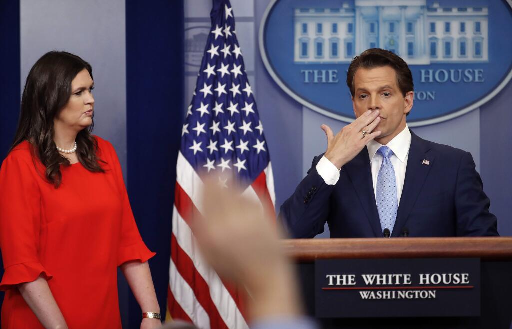 Sarah Huckabee Sanders, left, who has been named White House press secretary, watches as incoming White House communications director Anthony Scaramucci, right, blowing a kiss after answering questions during the press briefing in the Brady Press Briefing room of the White House in Washington, Friday, July 21, 2017. (AP Photo/Pablo Martinez Monsivais)