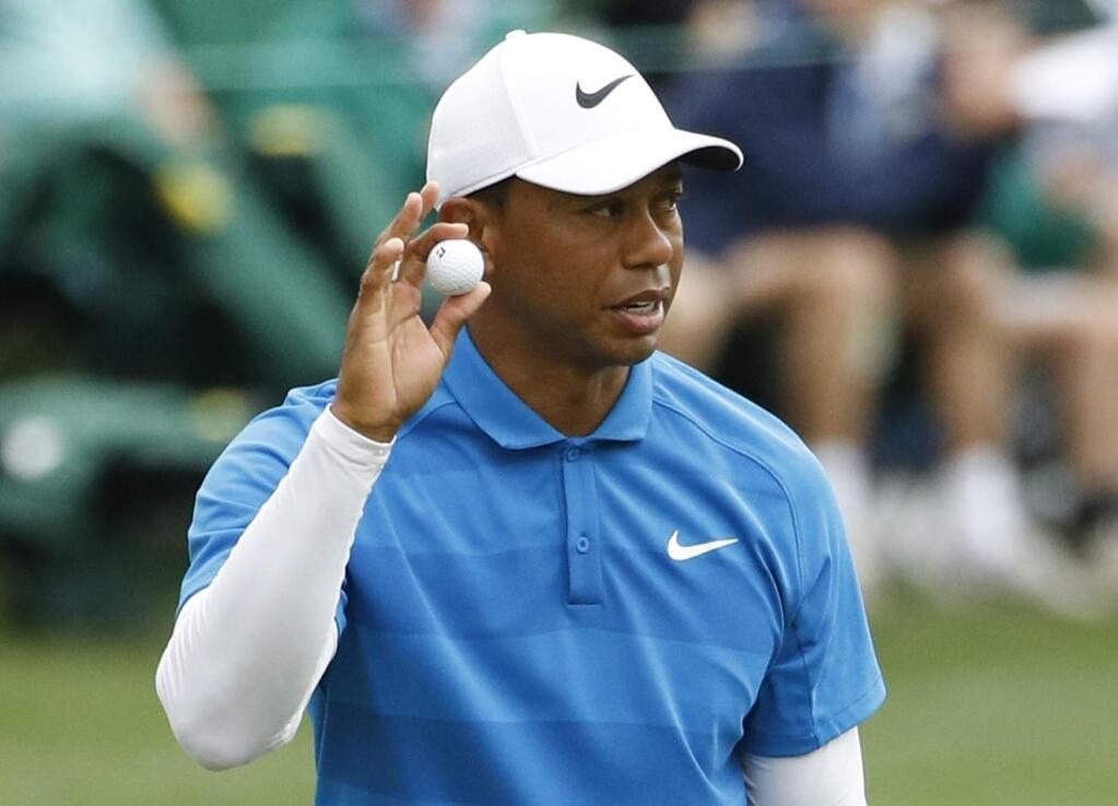 Tiger Woods reacts after his birdie on the 16th hole during the third round at the Masters golf tournament Saturday, April 7, 2018, in Augusta, Ga. (AP Photo/Charlie Riedel)
