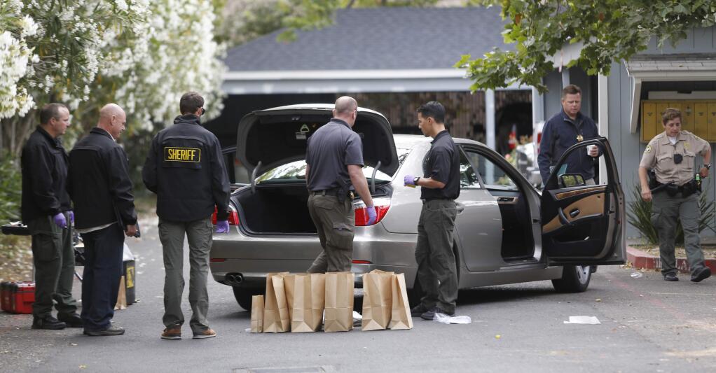 Sonoma County sheriff's deputies and detectives collect evidence from a gang related shooting Monday morning near a Corby Avenue apartment complex in Santa Rosa, July 6, 2015. (BETH SCHLANKER/ The Press Democrat)