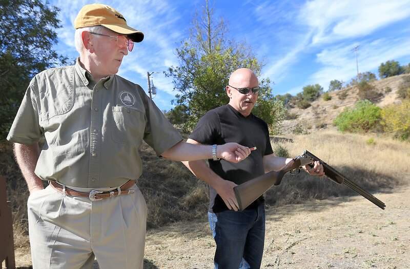Congressman Mike Thompson Rep. (D-CA 5th District) of St. Helena, left, hands more ammunition to retired Navy captain, combat pilot and Space Shuttle commander Mark Kelly (husband of Gabrielle Dee 'Gabby' Giffords) as Kelly prepares to shoot clay pigeons with other gun owners at the Napa Police shooting range in Napa, Friday July 16, 2013. Thompson is the chair of the House Gun Violence Prevention Task Force. (Kent Porter / Press Democrat) 2013