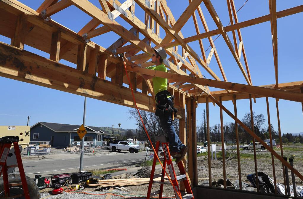 Josh Wilson works on framing a home along San Miguel Avenue in the Coffey Park area of Santa Rosa on Monday, April 23, 2018. (CHRISTOPHER CHUNG/ PD)