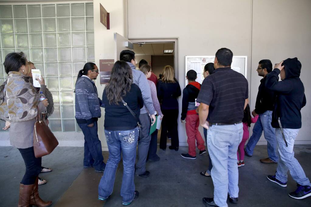 People file into Traffic Court at the Hall of Justice in Santa Rosa, on Tuesday, May 12, 2015. (BETH SCHLANKER/ The Press Democrat)