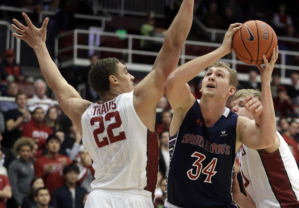 Saint Mary's Jock Landale, right, shoots against Stanford's Reid Travis (22) during the first half Wednesday, Nov. 30, 2016, in Stanford. (AP Photo/Ben Margot)
