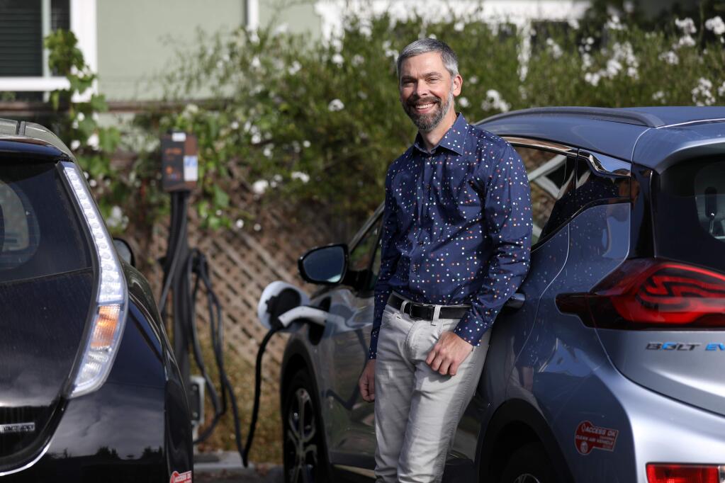 Geof Syphers, the CEO of Sonoma Clean Power, stands near a charging station for electric vehicles at Frogsong Cohousing in Cotati on Aug. 2, 2019. He is a big advocate of off-shore wind energy to solve the afternoon and evening electricity demand to charge vehicles. (BETH SCHLANKER/The Press Democrat)