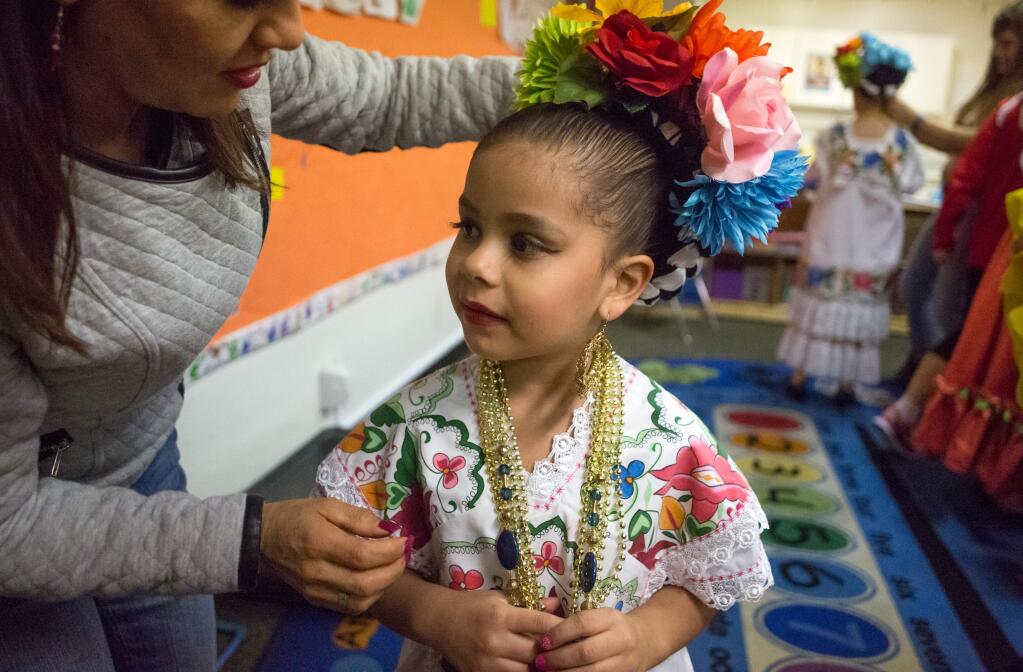 Lorena Avalos gets into costume before performing with Ballet Folklorico Netzahualcoyotl during a pozole feed fundraiser at Roseland Elementary School in Santa Rosa, Calif., Friday, January 30, 2015. (Jeremy Portje / For Press Democrat)