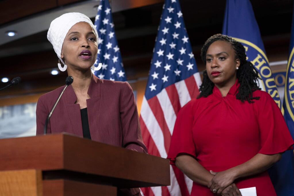 U.S. Rep. Ilhan Omar, D-Minn., joined at right by U.S. Rep. Ayanna Pressley, D-Mass., responds to remarks by President Donald Trump after he called for four Democratic congresswomen of color to go back to their 'broken' countries, as he exploited the nation's glaring racial divisions once again for political gain, during a news conference at the Capitol in Washington, Monday, July 15, 2019. All four congresswomen are American citizens and three of the four were born in the U.S. Omar is the first Somali-American in Congress. (AP Photo/J. Scott Applewhite)